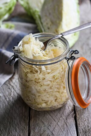 Sauerkraut on an open mason jar with a spoon